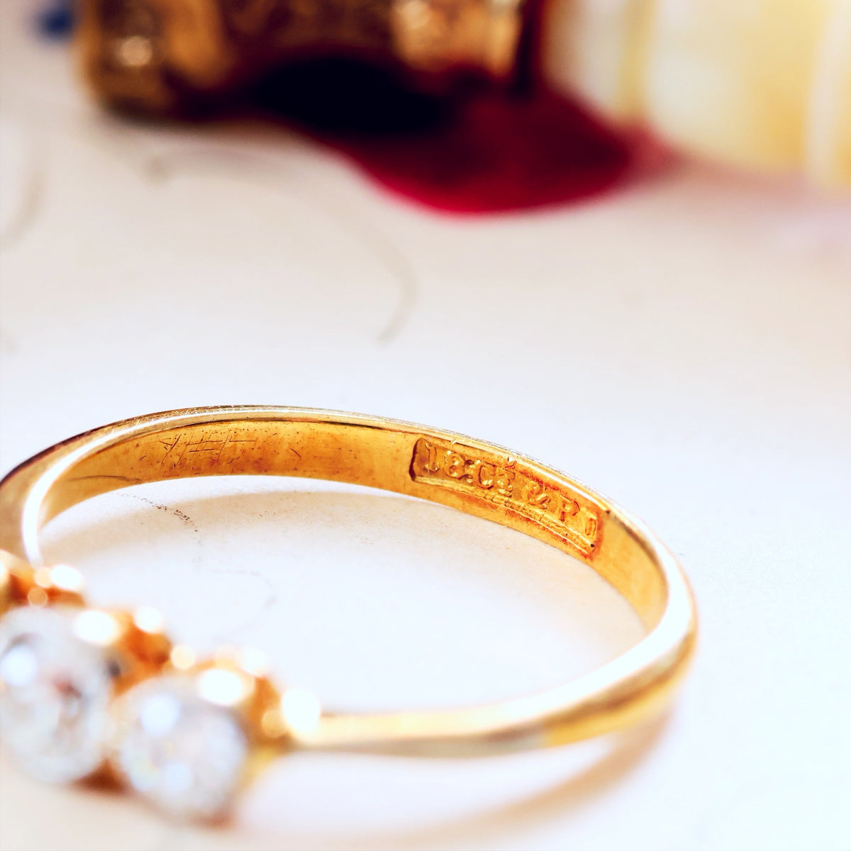 Gold ring with diamonds on a blurred background