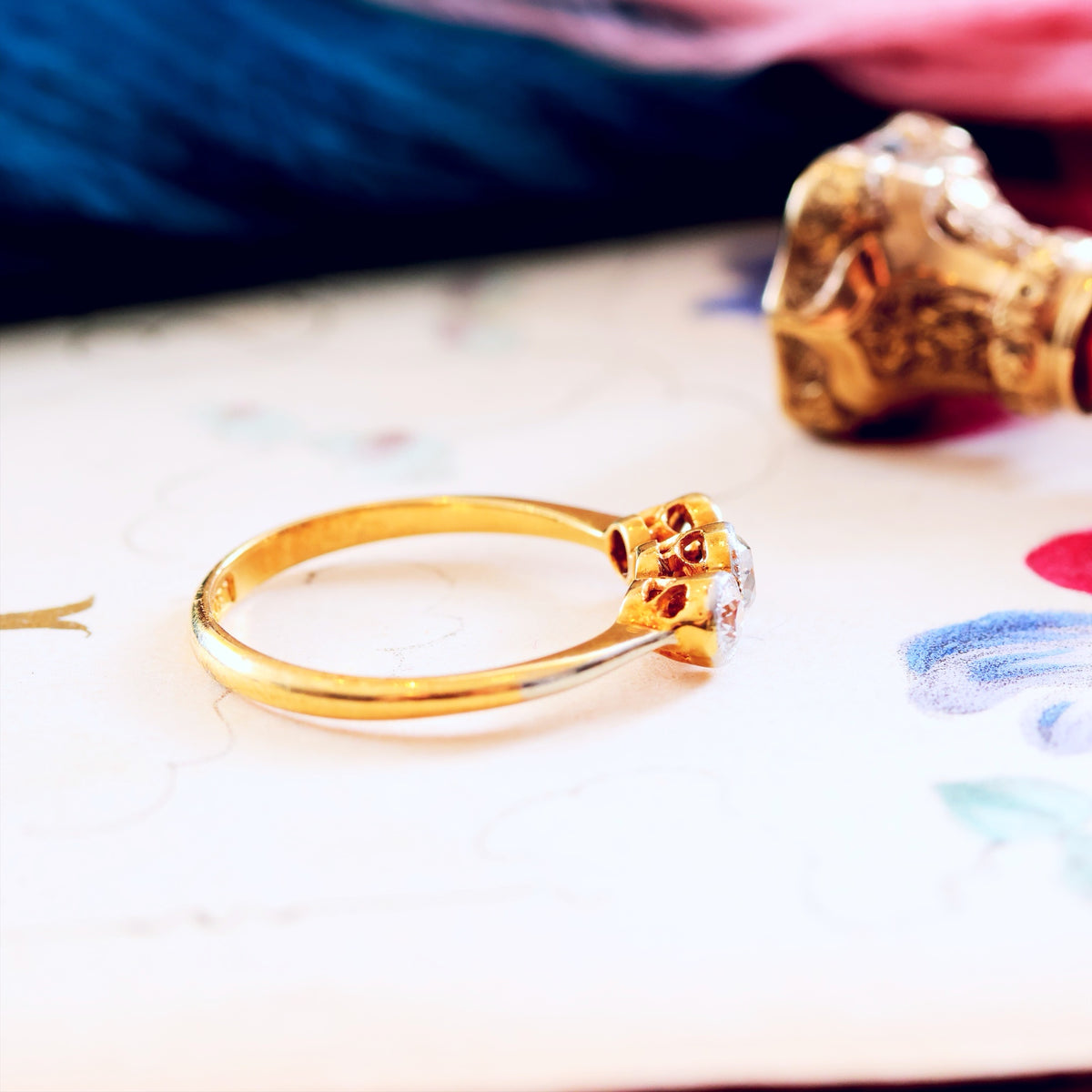 Gold ring with a diamonds on a colourful background