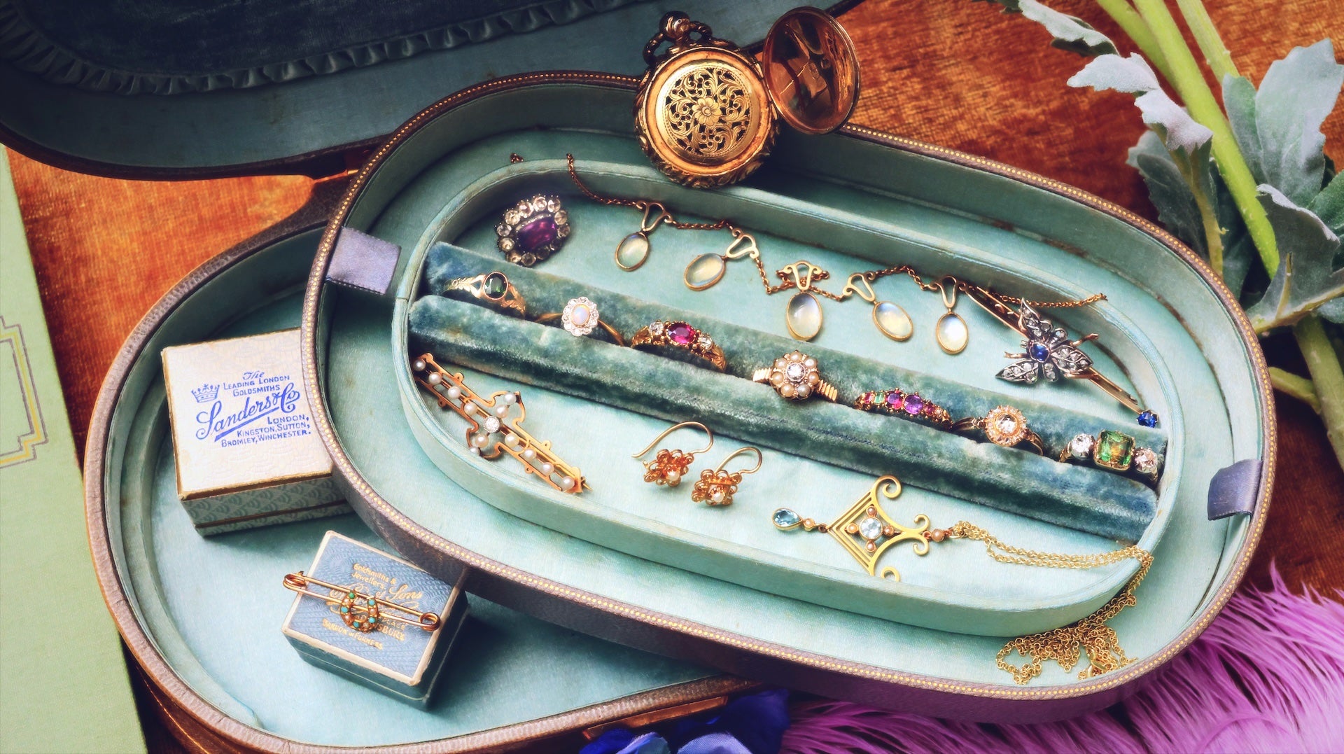 Antique jewellery set in a decorative box with a plant in the background