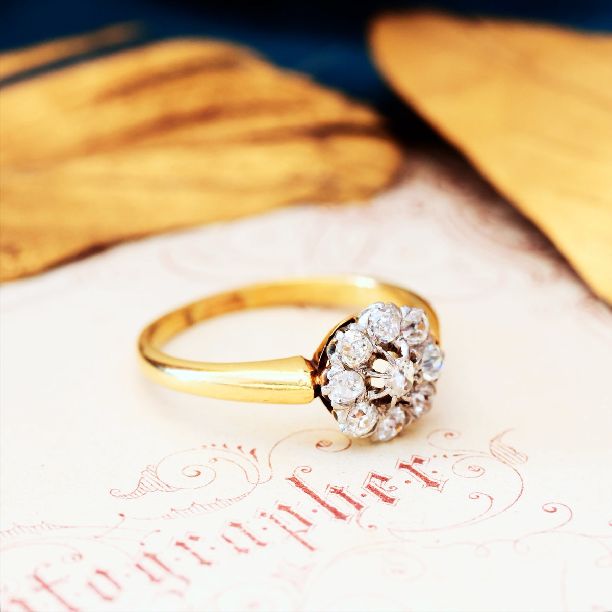 An Antique Hand Cut Diamond Cluster Engagement Ring